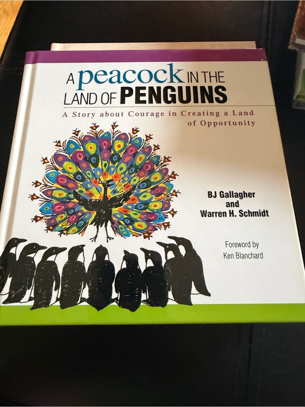 A Peacock in the Land of Penguins - Colorful Hardcover Book